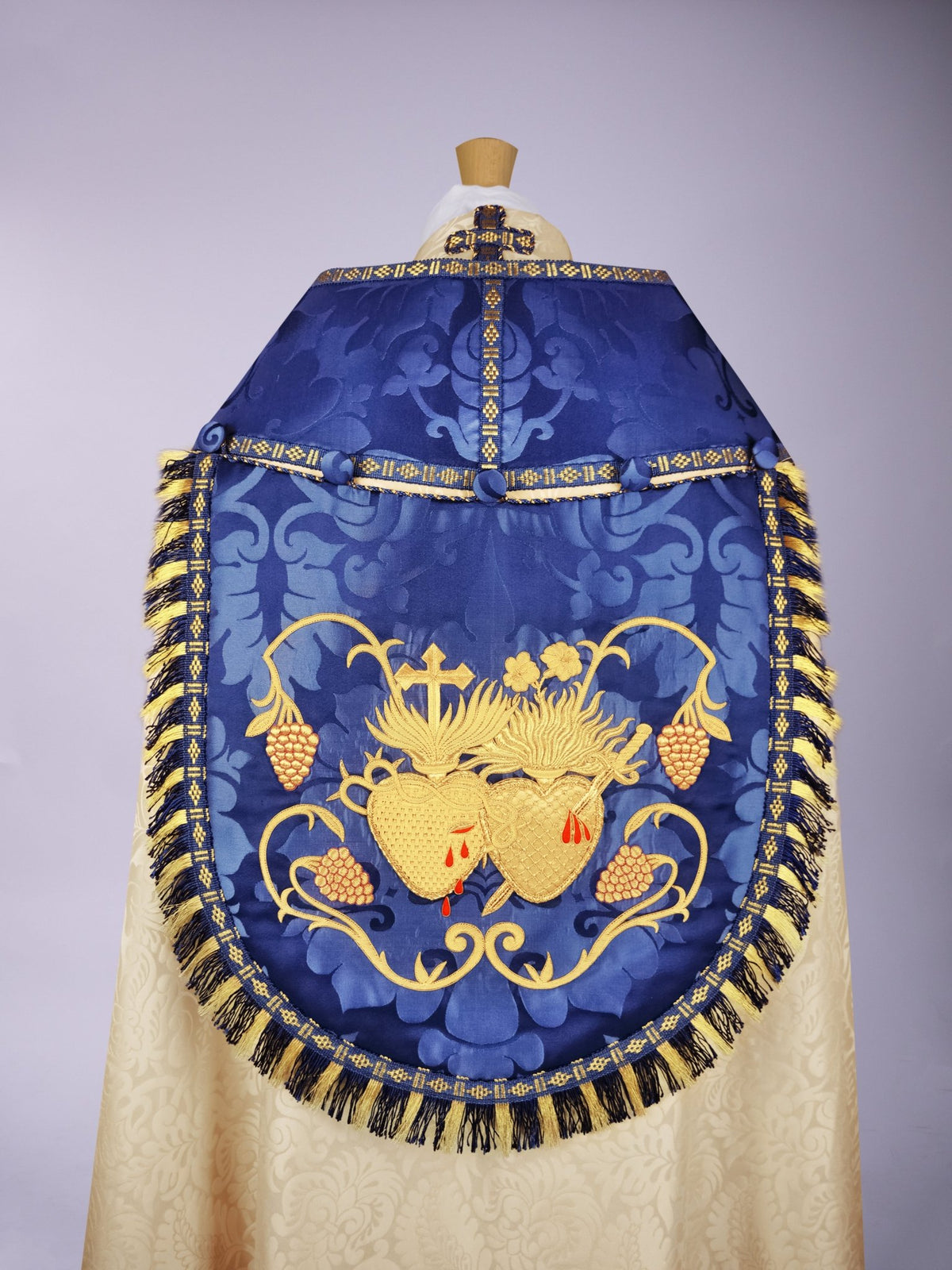 Minster Cope in Cream 'Holbein' with Blue 'Bellini' Orphreys and Sacred/Immaculate Heart Embroidered Hood - Watts & Co.