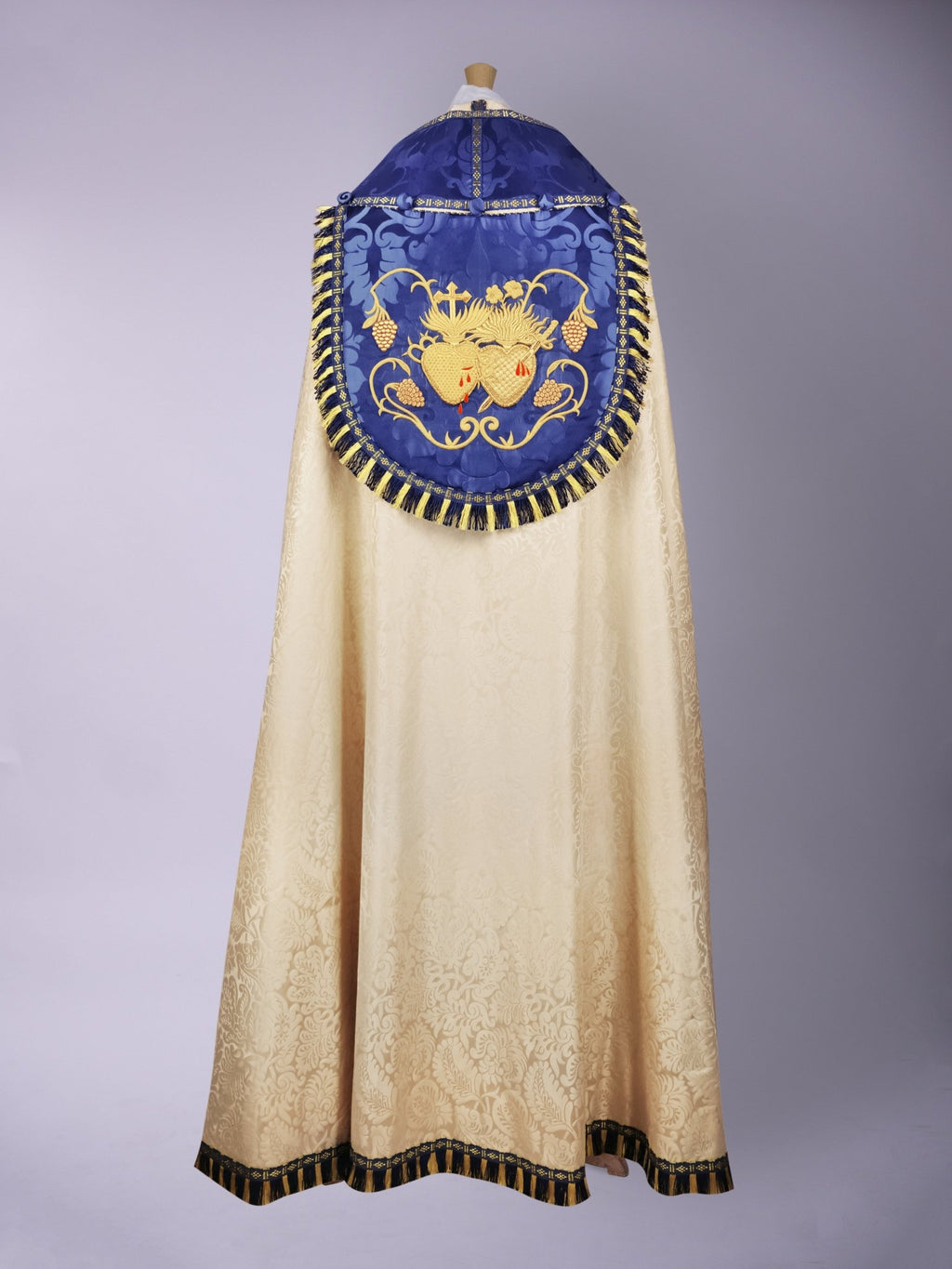 Minster Cope in Cream 'Holbein' with Blue 'Bellini' Orphreys and Sacred/Immaculate Heart Embroidered Hood - Watts & Co.