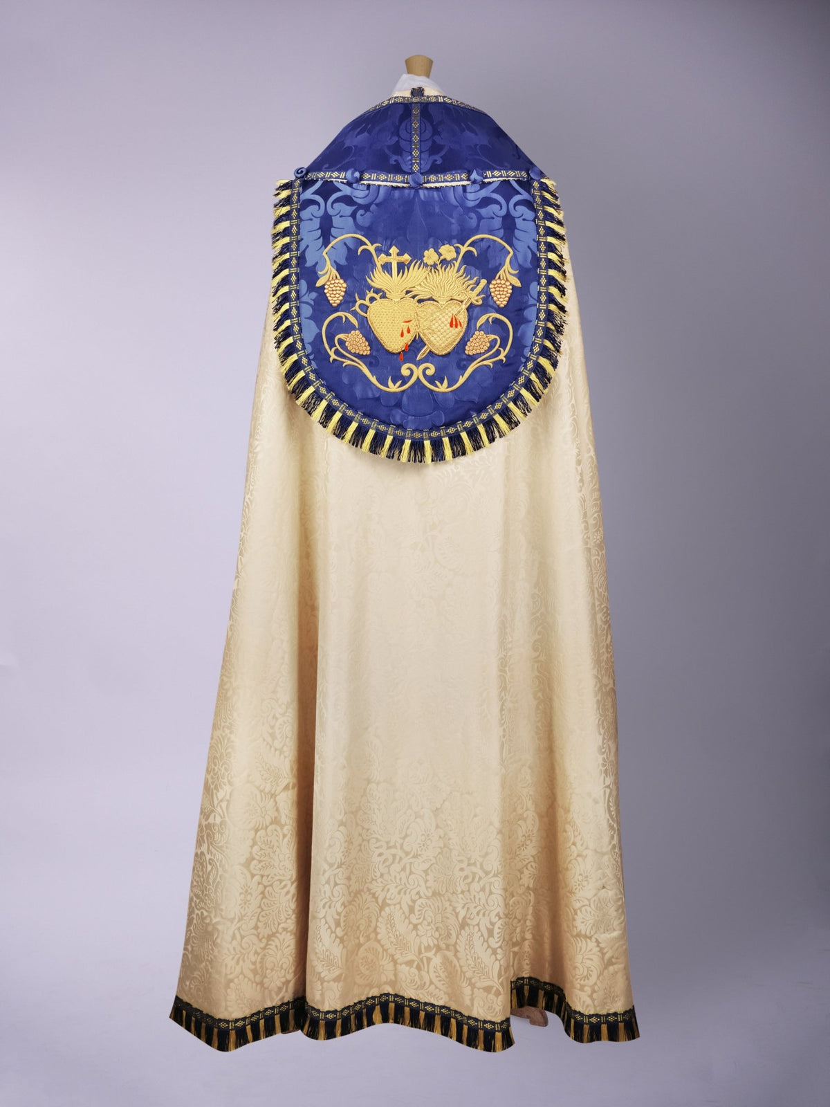 Minster Cope in Cream 'Holbein' with Blue 'Bellini' Orphreys and Sacred/Immaculate Heart Embroidered Hood - Watts & Co.