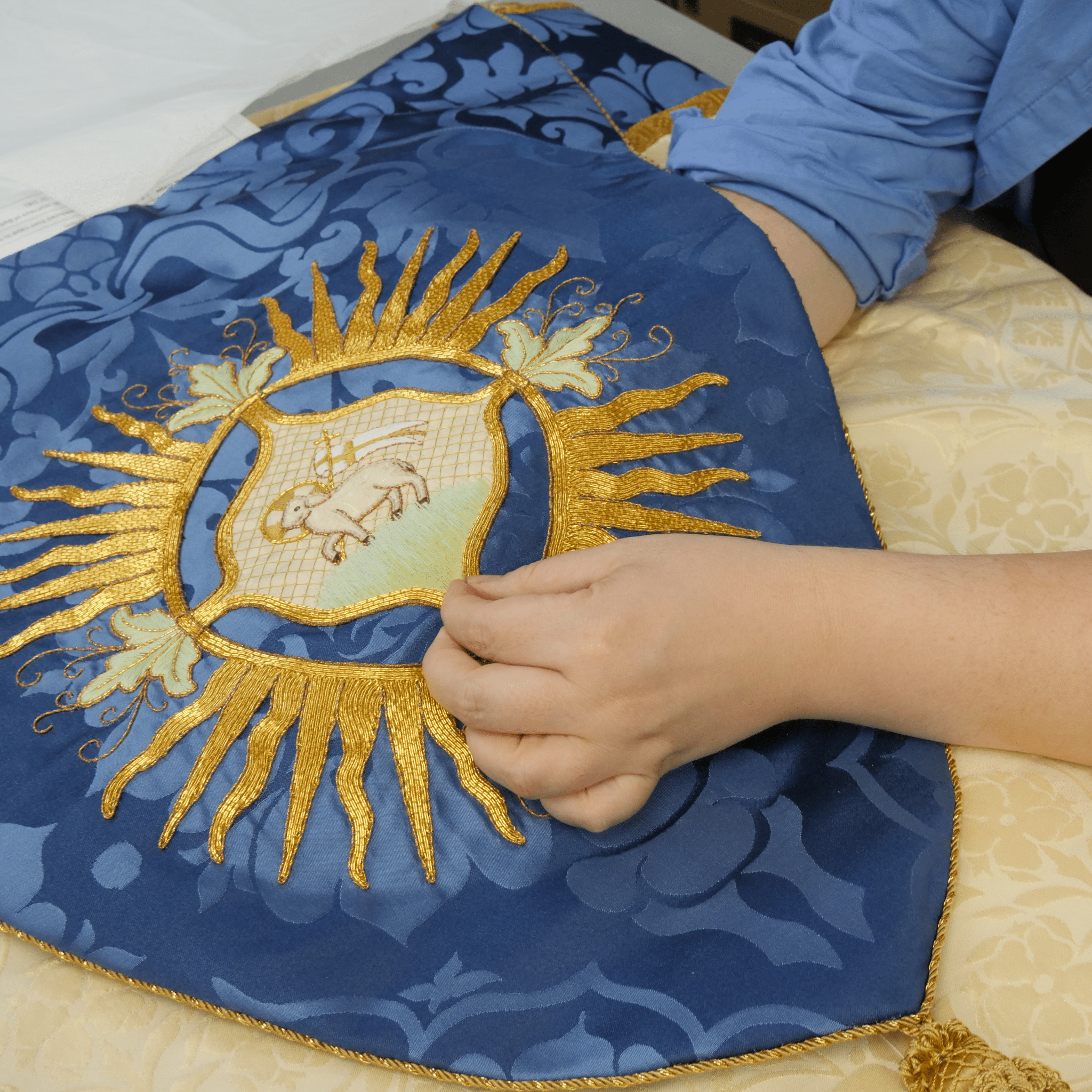 Minster Cope in Cream 'St John' Damask with Blue 'Bellini' Orphreys and Lamb of Gold Embroidered Hood - Watts & Co.