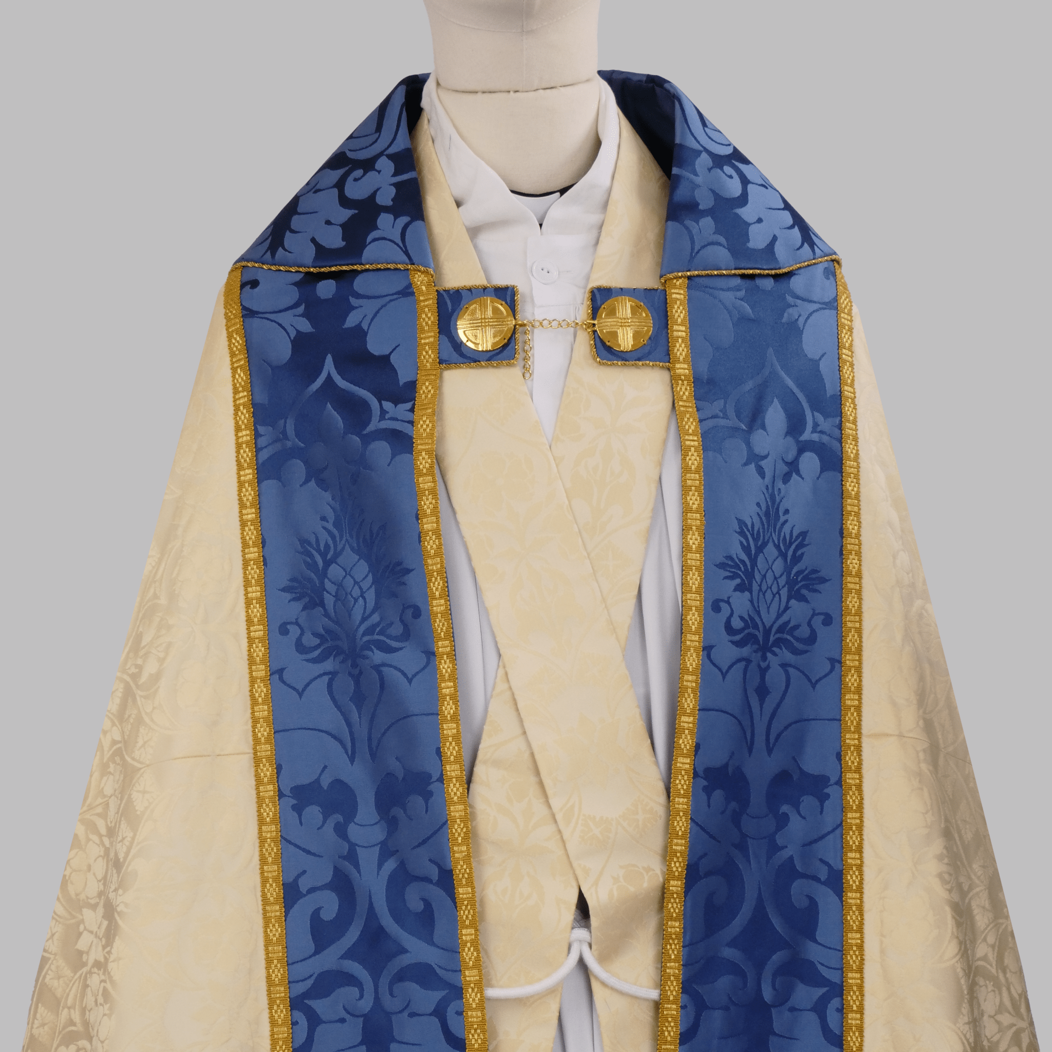 Minster Cope in Cream 'St John' Damask with Blue 'Bellini' Orphreys and Lamb of Gold Embroidered Hood - Watts & Co.