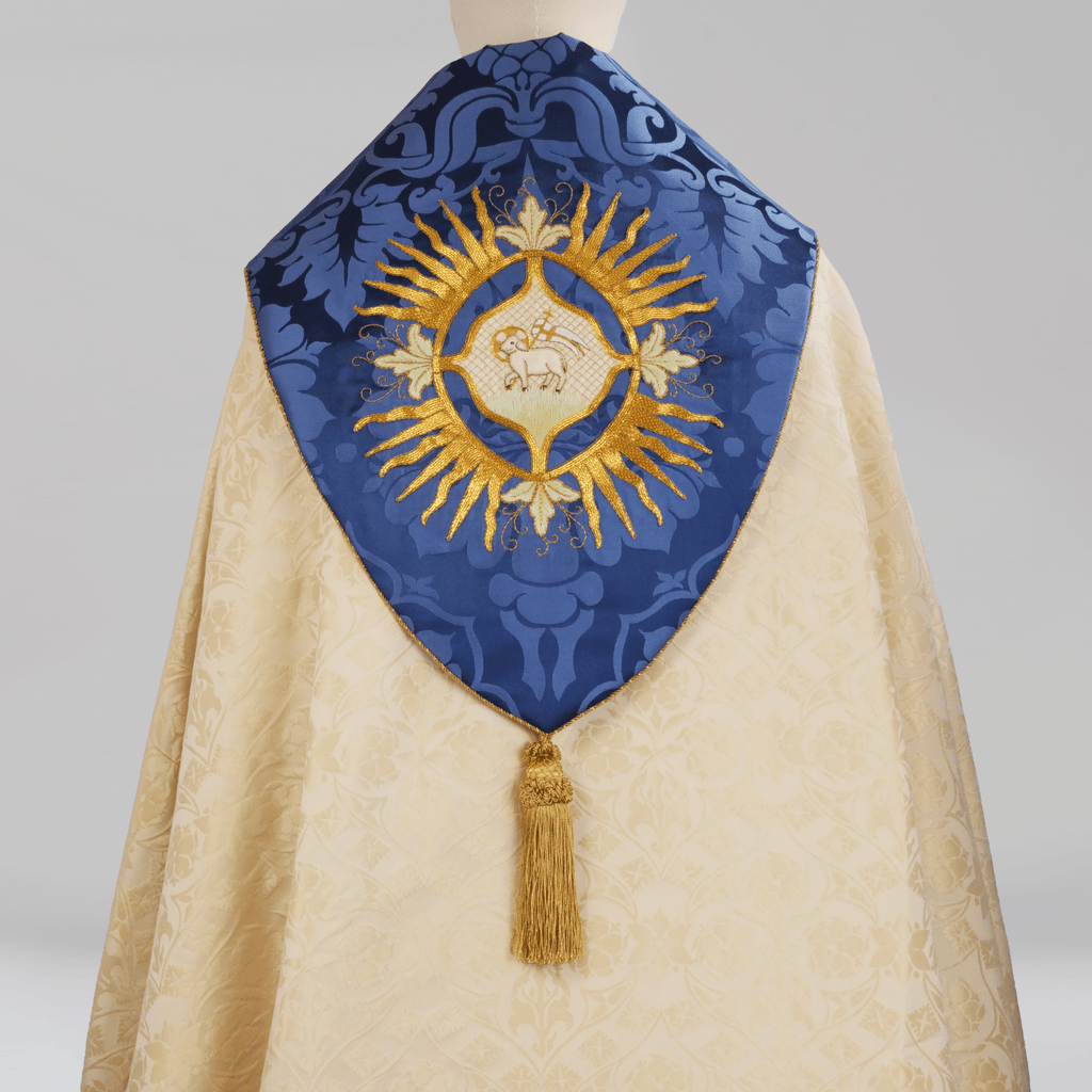 Minster Cope in Cream 'St John' Damask with Blue 'Bellini' Orphreys and Lamb of Gold Embroidered Hood - Watts & Co.
