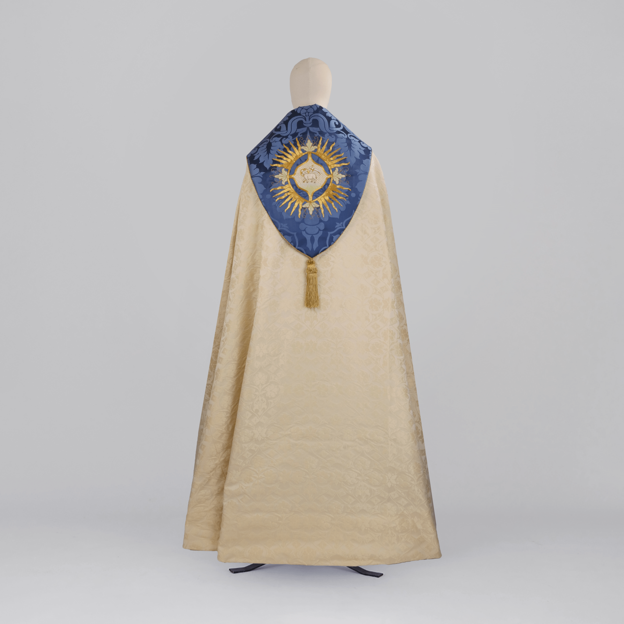 Minster Cope in Cream 'St John' Damask with Blue 'Bellini' Orphreys and Lamb of Gold Embroidered Hood - Watts & Co.