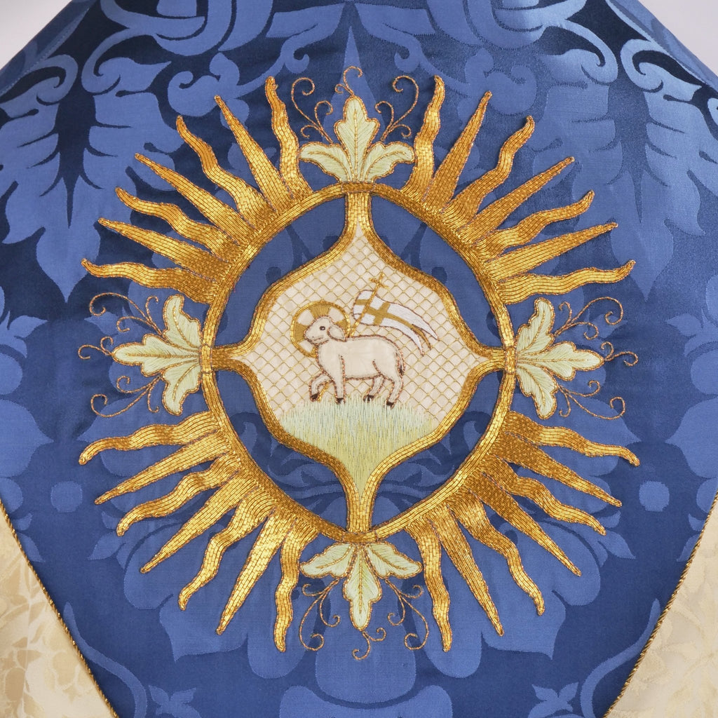 Minster Cope in Cream 'St John' Damask with Blue 'Bellini' Orphreys and Lamb of Gold Embroidered Hood - Watts & Co.