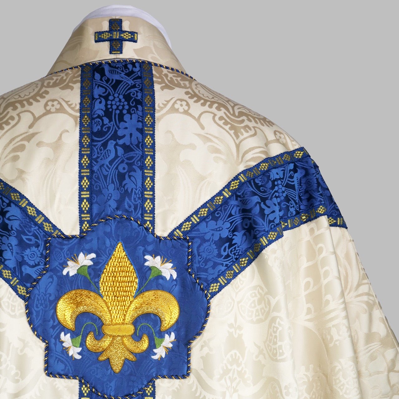 Semi - Gothic Chasuble in Cream 'Comper Cathedral' Silk Damask with Blue 'Hilliard' Orphreys and Fleur du Lys Embroidery - Watts & Co.