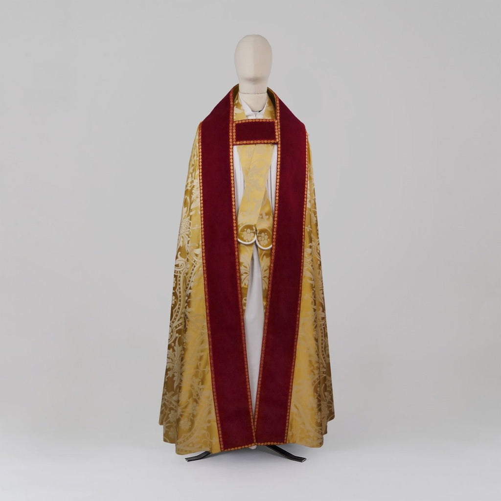 Westminster Cope in Gold/Cream 'Shrewsbury' with Berry 'Venice' Velvet orphreys and an IHS Hand - Embroidered Hood - Watts & Co.