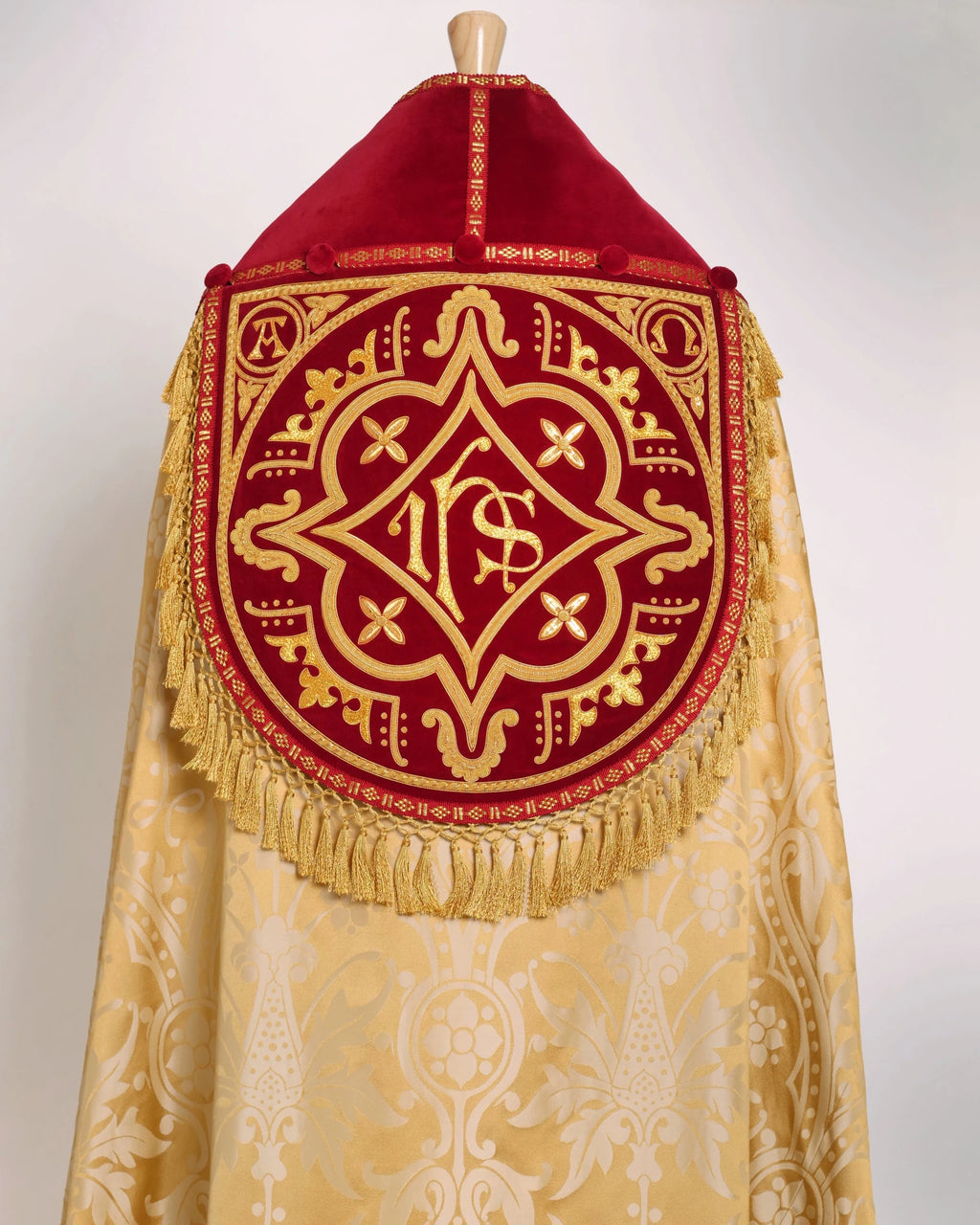 Westminster Cope in Gold/Cream 'Shrewsbury' with Berry 'Venice' Velvet orphreys and an IHS Hand - Embroidered Hood - Watts & Co.