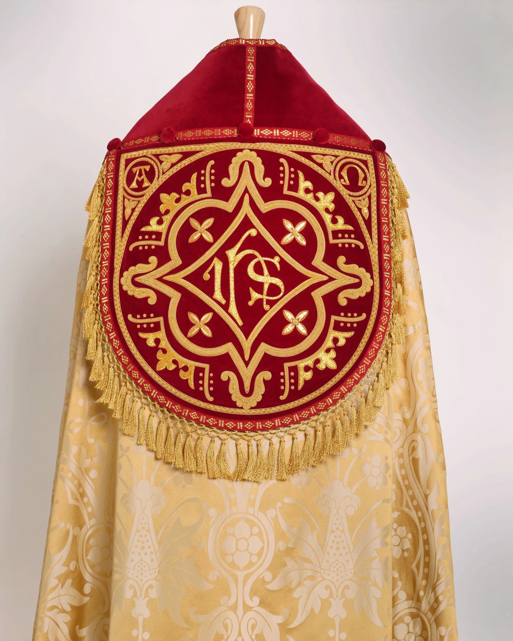 Westminster Cope in Gold/Cream 'Shrewsbury' with Berry 'Venice' Velvet orphreys and an IHS Hand - Embroidered Hood - Watts & Co.