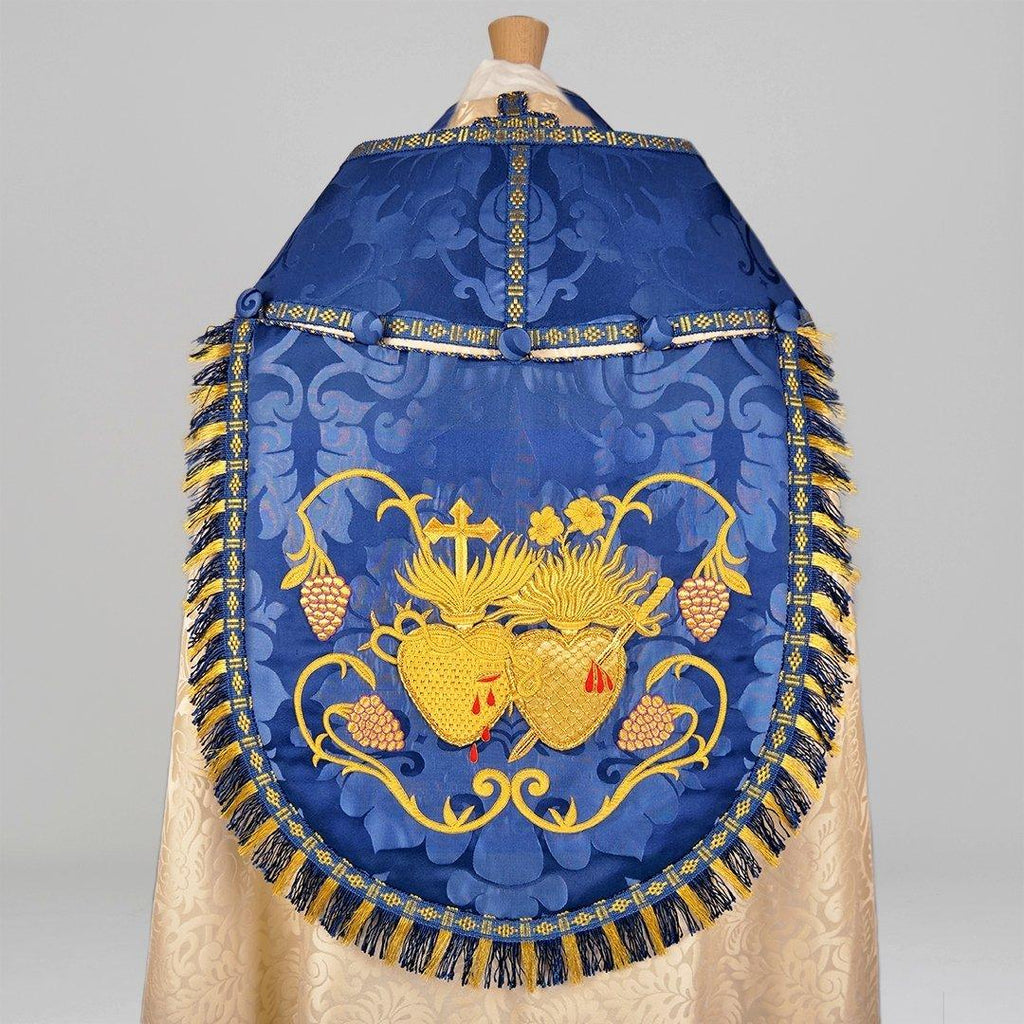Minster Cope in Cream 'Holbein' with Blue 'Bellini' Orphreys and Sacred/Immaculate Heart Embroidered Hood - Watts & Co.