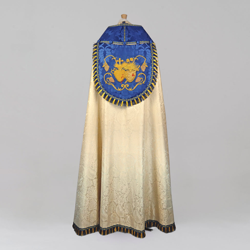 Minster Cope in Cream 'Holbein' with Blue 'Bellini' Orphreys and Sacred/Immaculate Heart Embroidered Hood - Watts & Co.